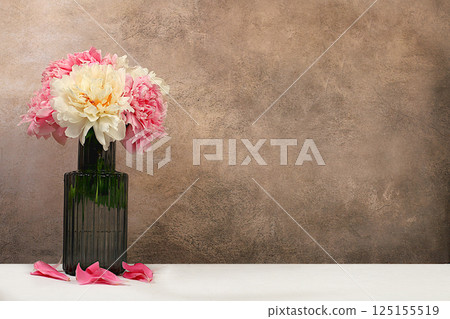 Abstract floral arrangement for holiday greeting card. Beautiful live peonies in elegant vase, gift for beloved. Design template and screen background. Spring greeting concept 125155519