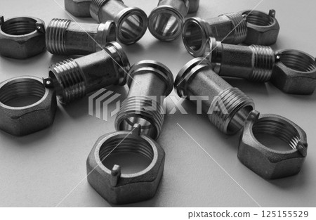 Cast Iron Sanitary And Tubing Accessories. Joint Fittings And Plumbing Nuts Laid Out In Star Shape On White Angle View Stock Photo 125155529