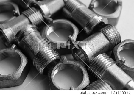 Set Of Dark Iron Piping Fittings And Plumbing Nuts Detailed Angle View. Pipe And Tube Cast Iron Connectors Isolated On White  125155532