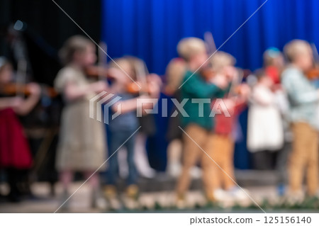 Defocused violin concert at an elementary school on stage Defocused violin concert at an elementary school on stage 125156140