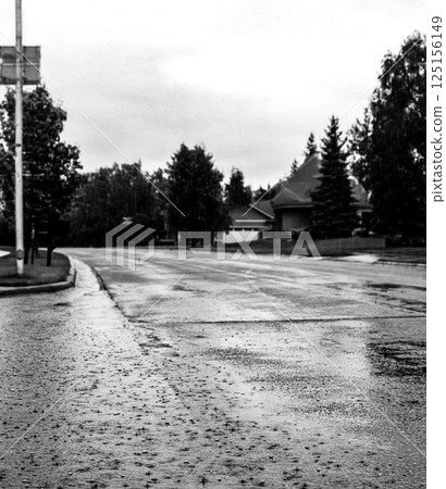 Backed up standing water on a residential street after a rain storm downpour.  125156149