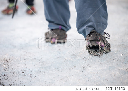 Selective focus on chain spikes on a pair of shoes for added traction on ice.  125156150