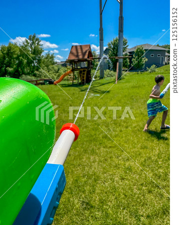 First person point of view spraying a pressurized toy water gun 125156152