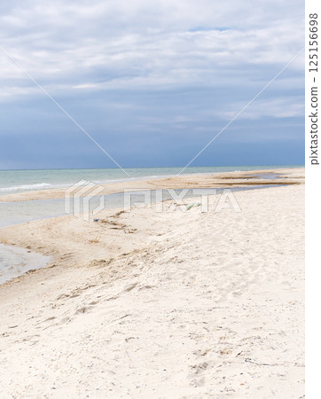 picturesque summer beach with white sand, blue sea and rich sky. A sandy beach 125156698