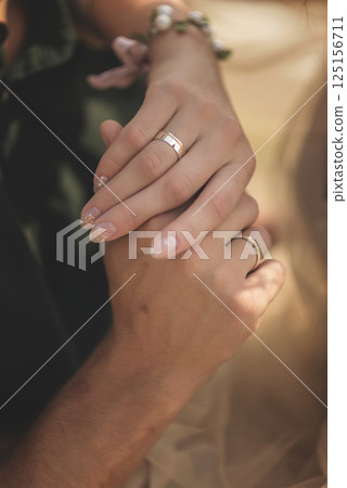 wedding rings at a wedding and hands close-up 125156711
