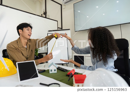 Eco-Friendly Strategy and Measuring Techniques. Team innovating sustainable solutions for future construction projects. 125156963