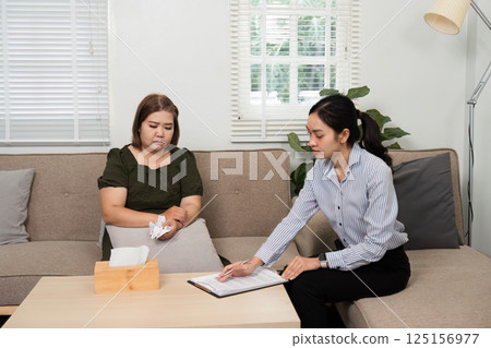 Dialogue and Reflection. A therapist and client engage in meaningful conversation during a therapy session. 125156977