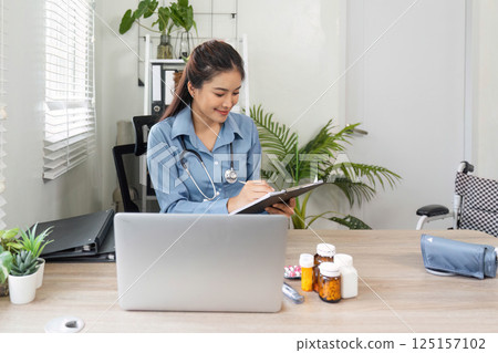 Health Management and Record Keeping. A healthcare professional takes notes while ensuring comprehensive patient care. Health Management and Record Keeping. A healthcare professional takes notes while ensuring comprehensive patient care. 125157102
