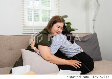 Emotional Support and Connection. A comforting hug shared between a psychiatrist and her client, fostering trust. 125157113