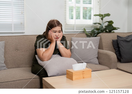 Introspection and Emotional Release. A client reflecting during a therapy session, experiencing a moment of vulnerability. Introspection and Emotional Release. A client reflecting during a therapy session, experiencing a moment of vulnerability. 125157128