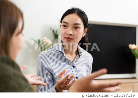 Therapeutic Conversation and Insight. A psychiatrist engaging in a meaningful dialogue with a client. 125157139