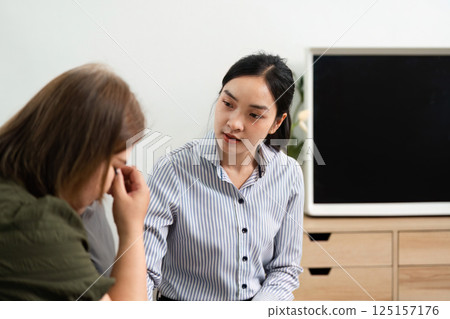 Empathy and Therapy. A psychiatrist provides a safe space for a client expressing emotions during a session. 125157176