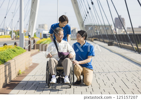 Senior men riding a wheelchair 125157207