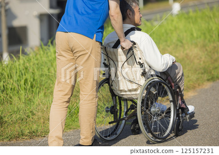 Senior men riding a wheelchair 125157231