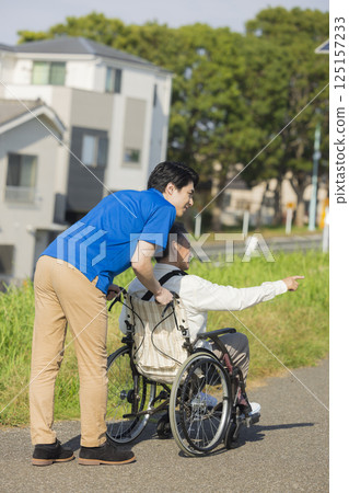 Senior men riding a wheelchair 125157233