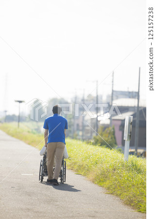 Senior men riding a wheelchair 125157238