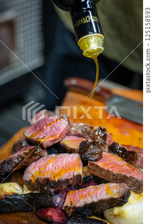 Finish with a drizzle of olive oil Finish with a drizzle of olive oil 125158593