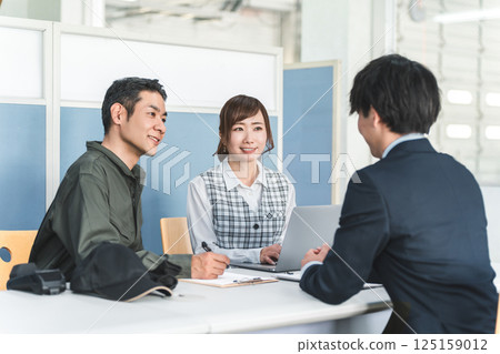 Male and female businessmen having a meeting, a conference, a meeting 125159012
