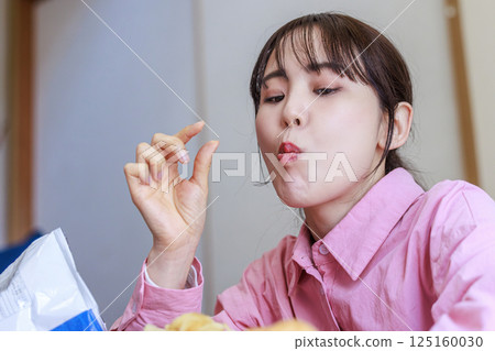 A woman eating sweets A woman eating sweets 125160030