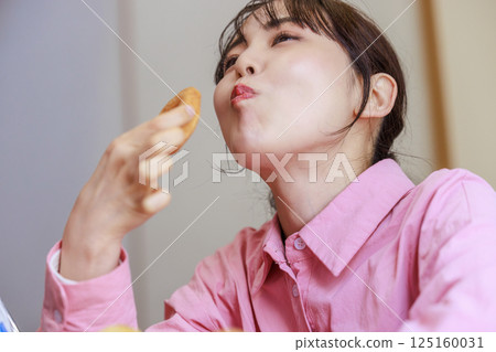 A woman eating sweets A woman eating sweets 125160031