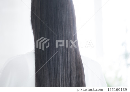 Back view of a woman with shiny long black hair 125160189