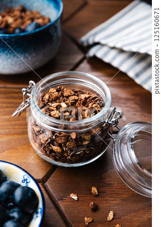Granola with chocolate, nuts and fresh blueberries. Healthy and simple breakfast. 125160671