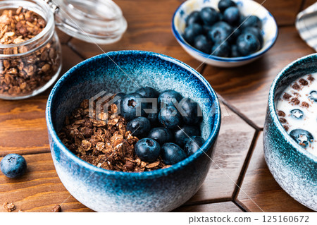 Granola with chocolate, nuts and fresh blueberries. Healthy and simple breakfast. 125160672