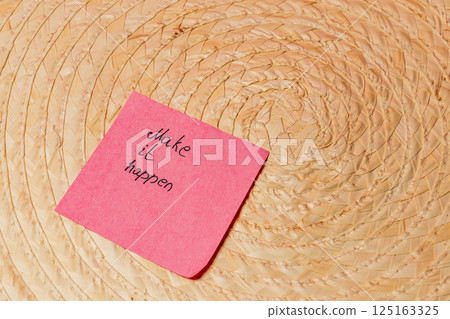 Motivational message on sticky note placed on a woven surface Motivational message on sticky note placed on a woven surface 125163325