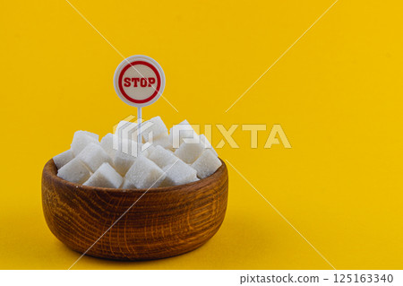Sugar bowl with a stop sign on a bright yellow background Sugar bowl with a stop sign on a bright yellow background 125163340