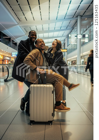 Friends Enjoying Laughter and Fun at the Airport Terminal During Their Travel Adventure 125163435