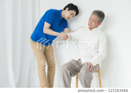 Senior men sitting in a chair 125163488