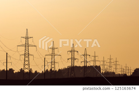 Silhouette of power transmission lines against the sunset sky Silhouette of power transmission lines against the sunset sky 125163674