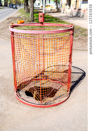 Special barriers block traffic during road repairs, pothole in the road, repairing road Special barriers block traffic during road repairs, pothole in the road, repairing road 125163838