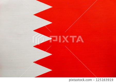 Bahrain national flag displayed against a blue background Bahrain national flag displayed against a blue background 125163919