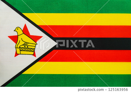 Zimbabwe flag featuring national emblem and vibrant colors 125163956