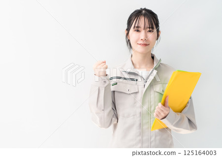 Young female engineer posing in a fist pump on white background Young female engineer posing in a fist pump on white background 125164003