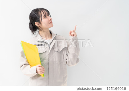 Young female engineer to pay attention to on white background Young female engineer to pay attention to on white background 125164016