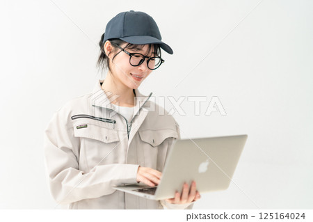 System engineer holding a PC, white background 125164024
