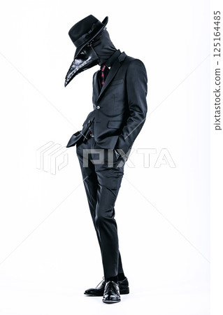 Plague doctor posing in a suit and plague mask 125164485