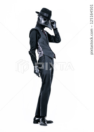 Plague doctor posing in a suit and plague mask Plague doctor posing in a suit and plague mask 125164501