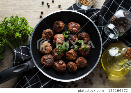 Meatballs in a pan on a wooden background 125164572
