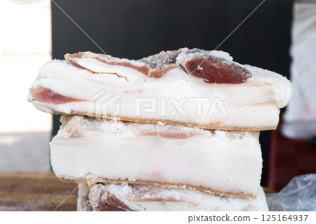 Chunks of salted pork lard on a counter 125164937