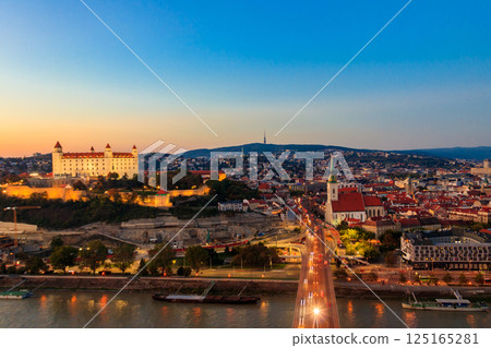 View of Bratislava castle, old town and the Danube river from observation deck the bridge in Bratislava, Slovakia at night View of Bratislava castle, old town and the Danube river from observation deck the bridge in Bratislava, Slovakia at night 125165281