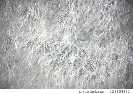 Detailed Microscopic View of Fabric Under a Microscope.Close-up view of fabric fibers under a microscope, revealing intricate texture and structural complexity. 125165382