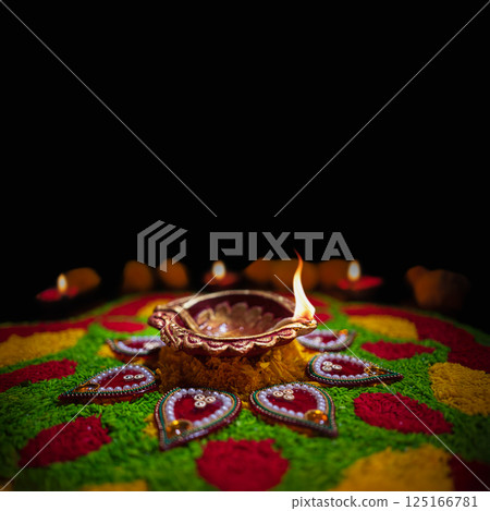 Clay diya lamps lit during diwali celebration, Diwali, or Dipawali, is India's biggest and most important holiday. 125166781