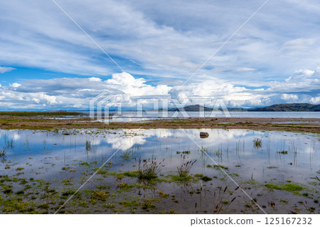 Llachon beach with a scenic view of Lake Titicaca, Peru Llachon beach with a scenic view of Lake Titicaca, Peru 125167232