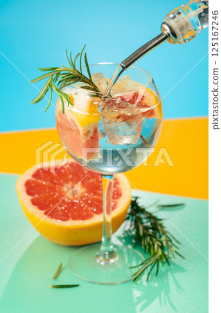 Refreshing summer cocktail with gin, tonic, grapefruit, and rosemary. Refreshing summer cocktail with gin, tonic, grapefruit, and rosemary. 125167246