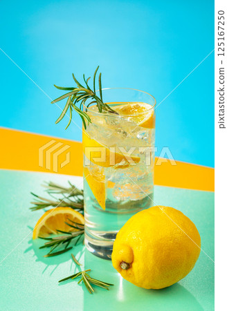 Refreshing cocktail with gin, tonic, lemon, and rosemary. Refreshing cocktail with gin, tonic, lemon, and rosemary. 125167250