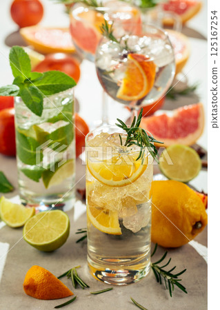 Refreshing summer cocktails with citrus on a white marble table. Refreshing summer cocktails with citrus on a white marble table. 125167254