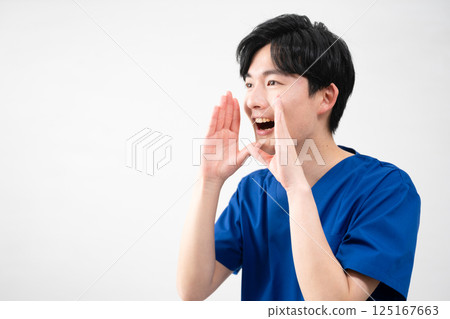 A young man wearing medical scrubs A young man wearing medical scrubs 125167663